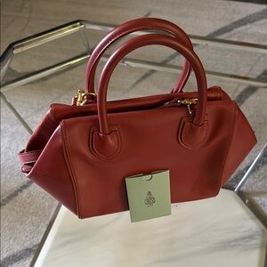 Sophisticated Red Satchel with Gold Accents and Structured Design